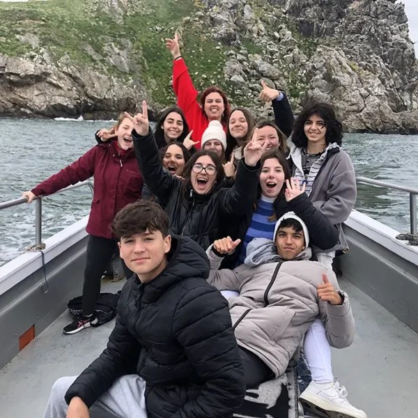 Student Tour Group on-board Ireland's Eye Ferry, in front of the island sea stacks.