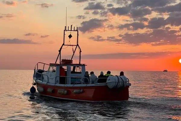 Boat on the water at sundown on Dublin Bay