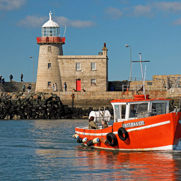 Orange Ireland's Eye Ferry boat enters Howth Harbour.
