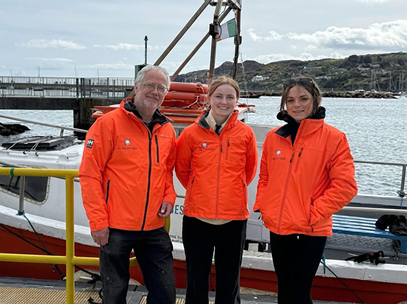 Three Skippers wearing high-viz jackets on Howth pier