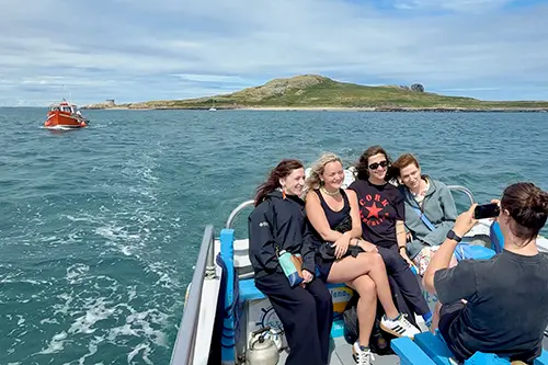 Group of women on-board Ireland's Eye Ferry take a photo.
