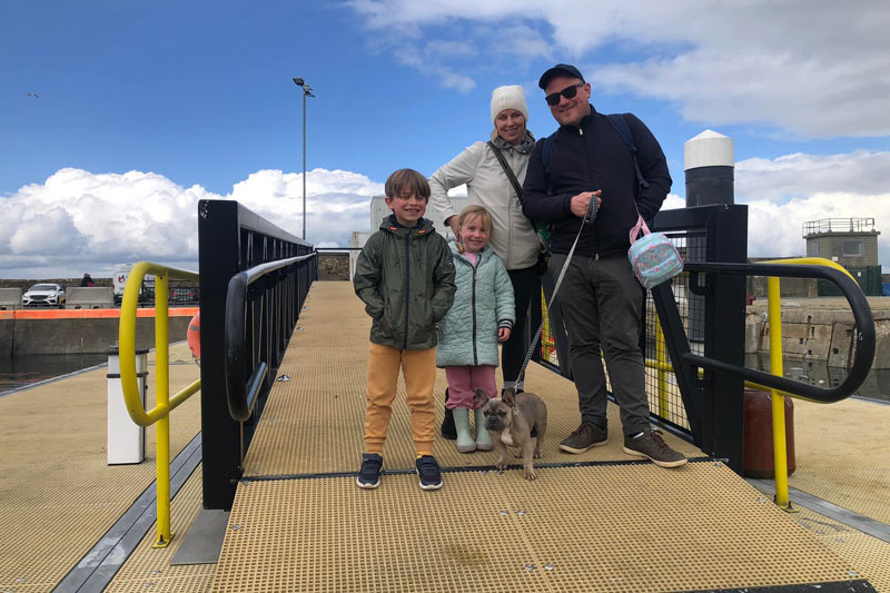 Family with Mom, Dad and two kids with Dog on the dock at Howth.