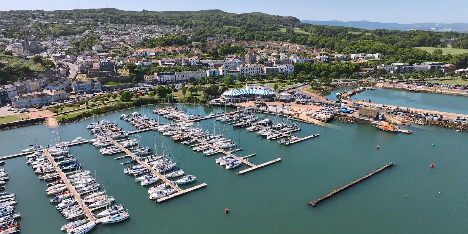 Aerial view of Howth Harbour, Dublin with docked boats and village.