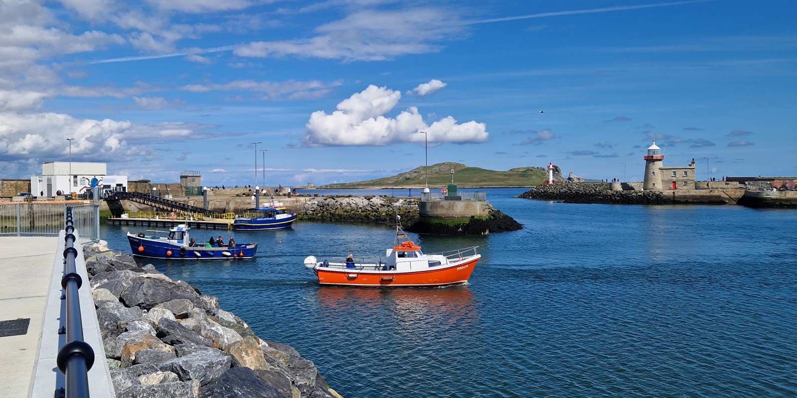 Orange Irelands Eye Ferry boat leaving Howth Harbour