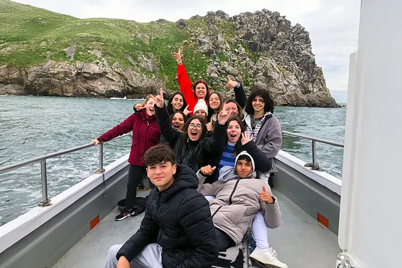 Group of students on-board Ireland's Eye Ferry, approaching the island.