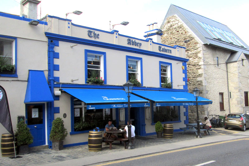 Light gray and blue shopfront of The Abbey Tavern in Howth, Dublin