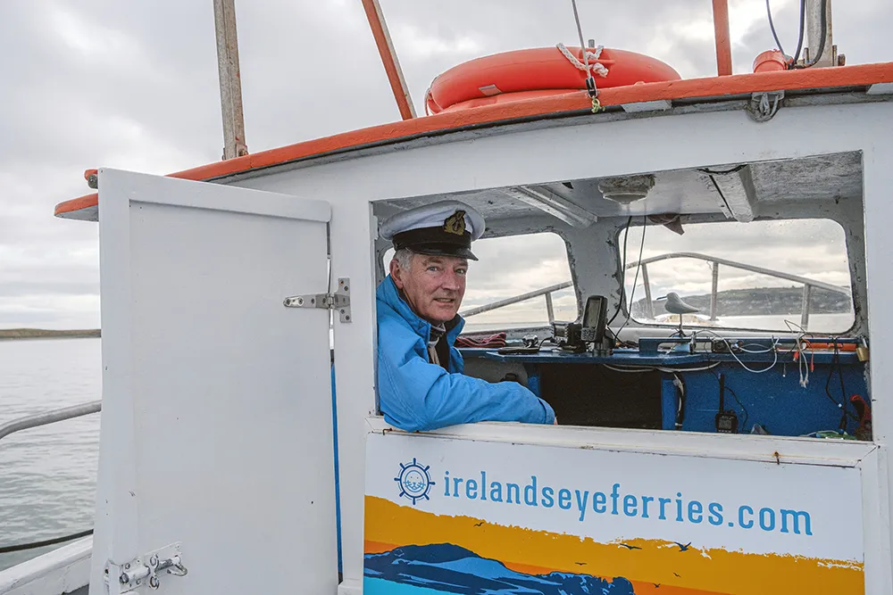 Shane O'Doherty in the Captain's cap in Ireland's Eye Ferry cabin.